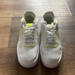 Nike Air Force 1’s with neon yellow swosh